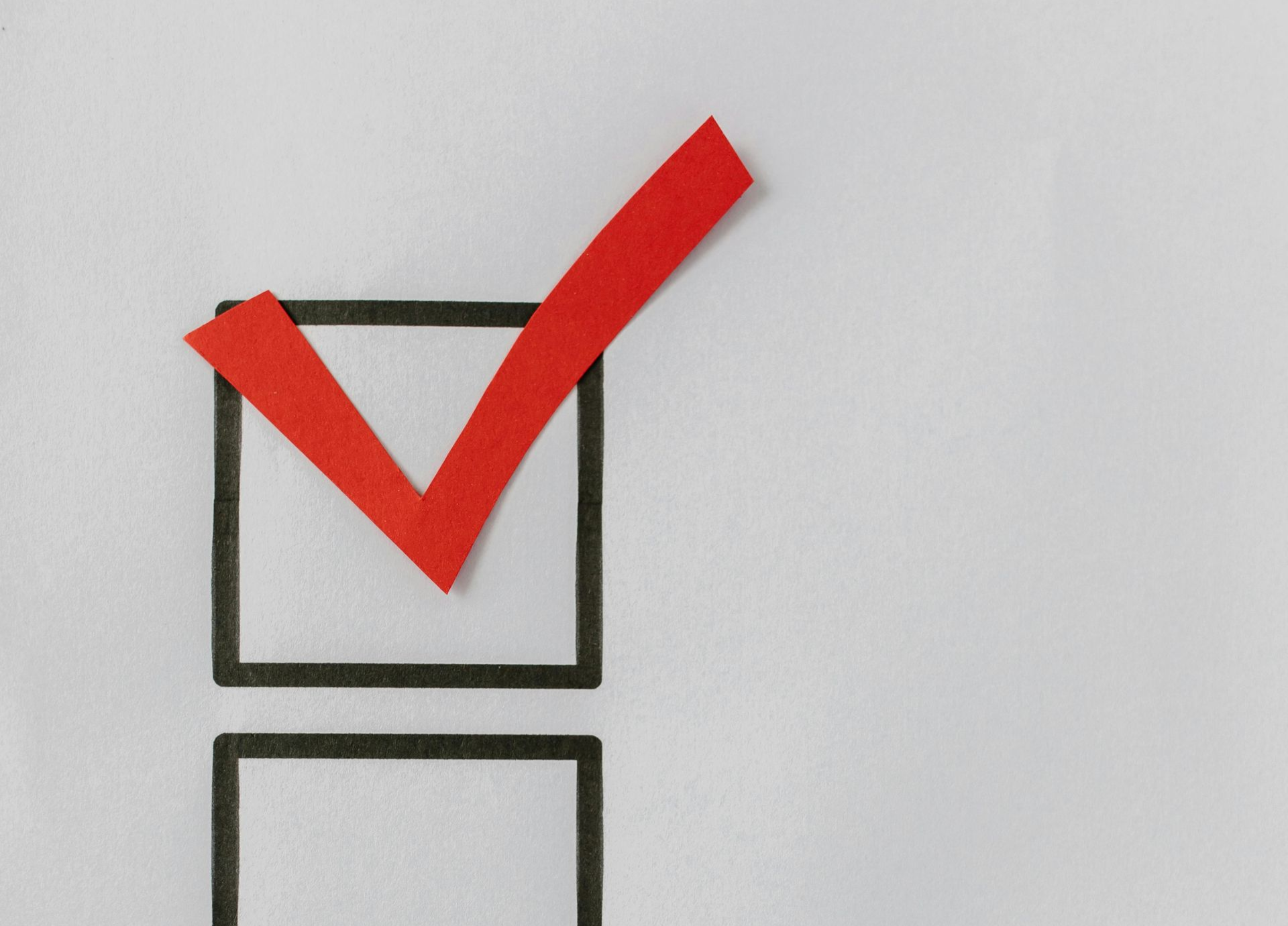 Checklist with a red checkmark on a light blue background.