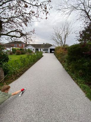 Resin driveway installation near Bristol, with light and dark aggregates mixed together.