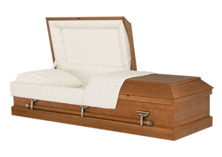 Wooden casket with the lid open, lined in white fabric and shown with a white pillow inside.
