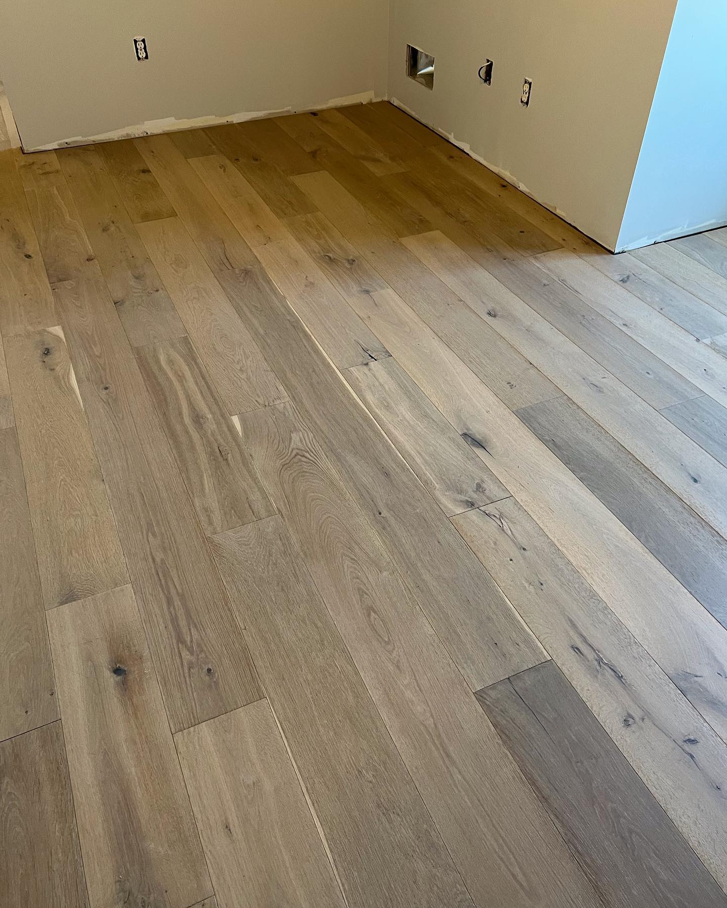 A room with a wooden floor and white walls.
