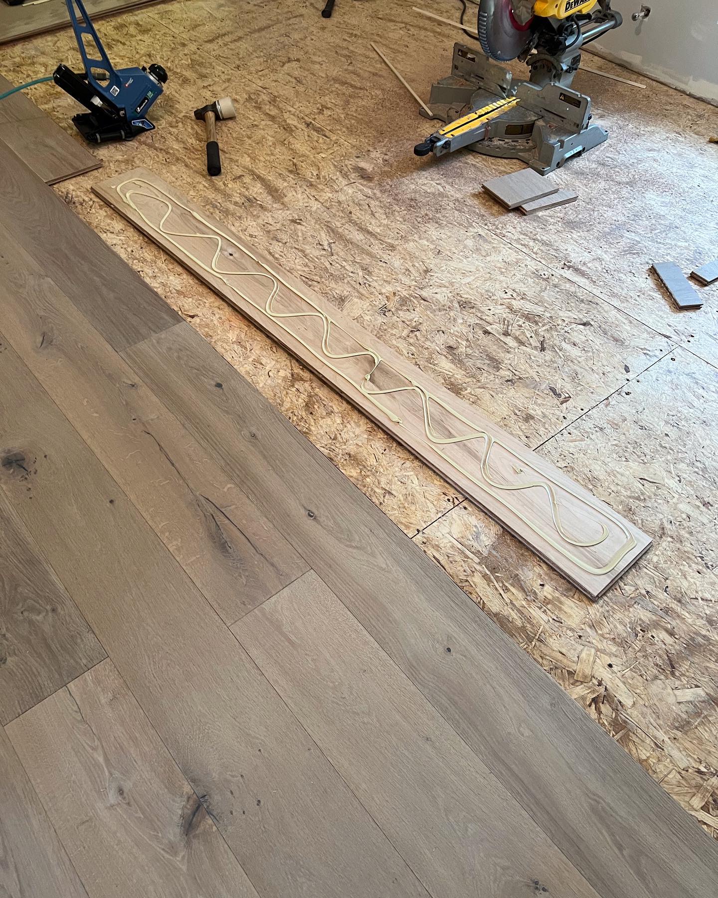 A wooden floor is being installed in a room.