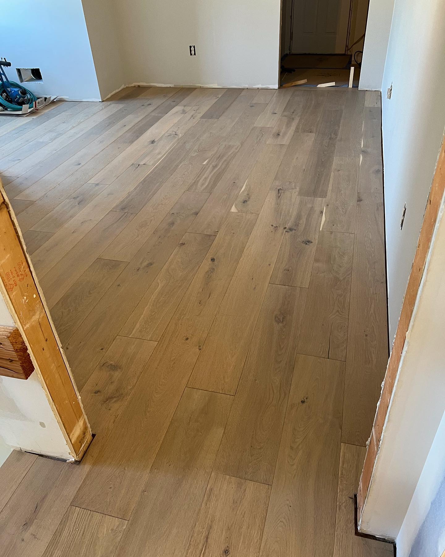 A wooden floor is being installed in a room.
