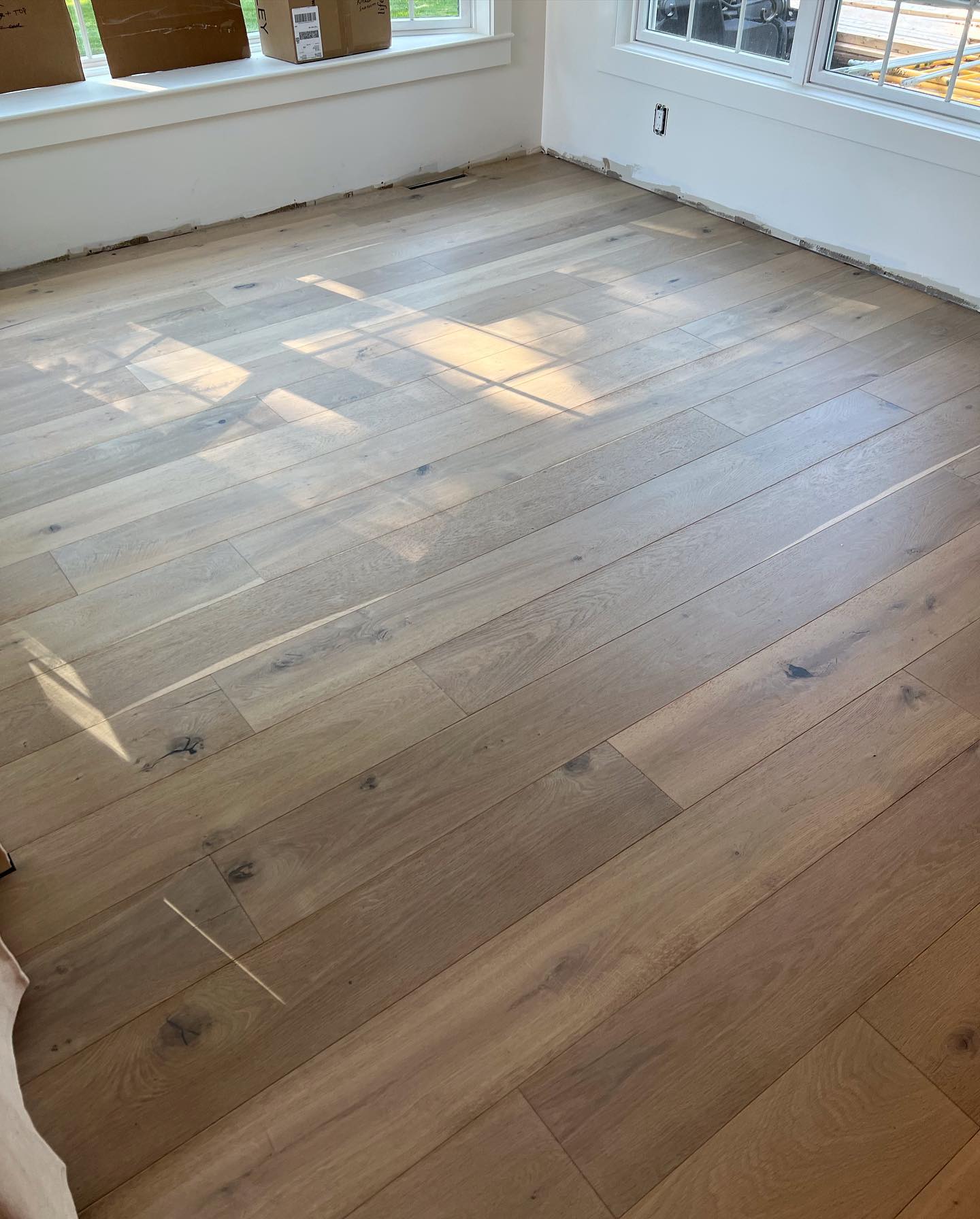A room with hardwood floors and a window.