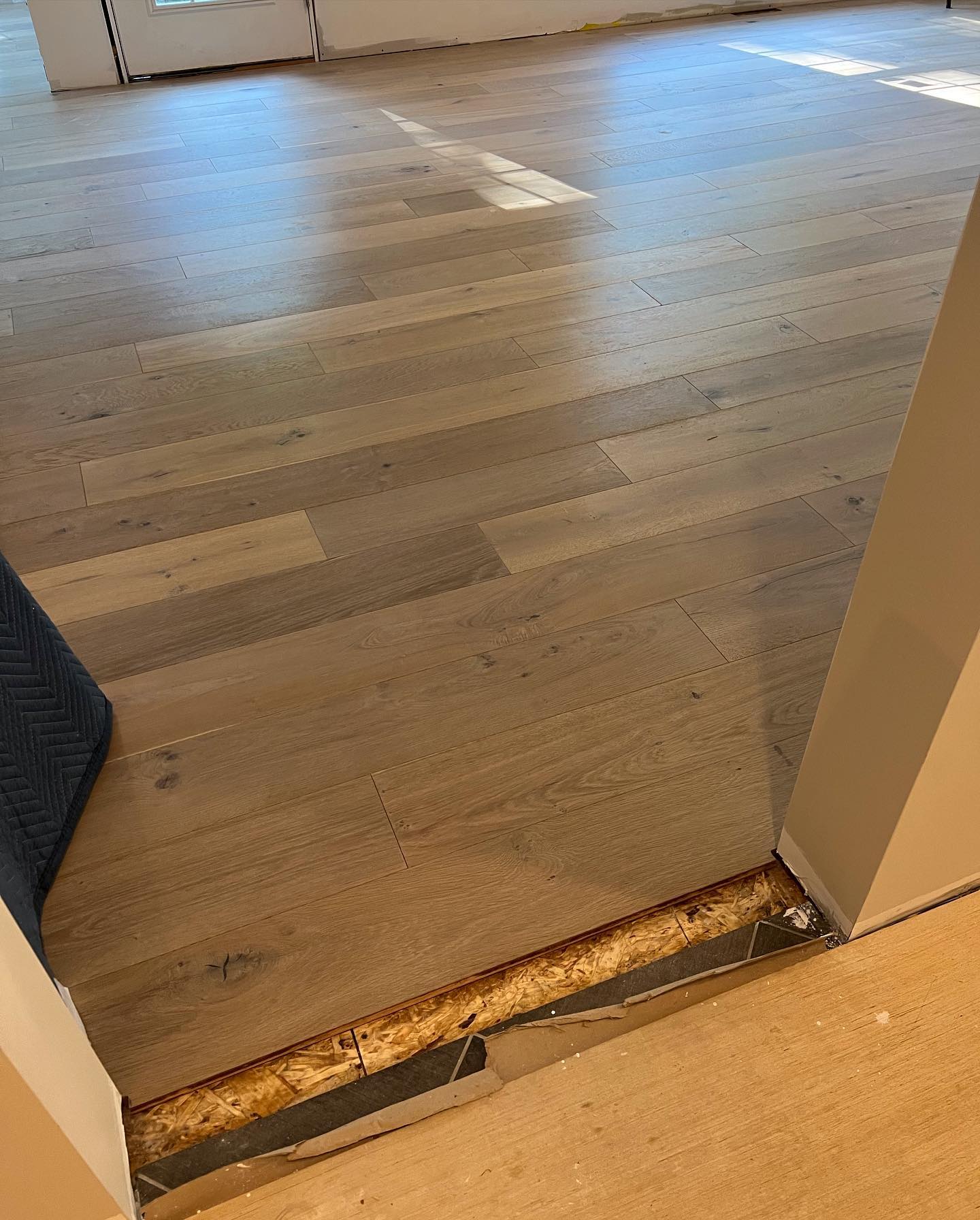 A close up of a wooden floor in a room.