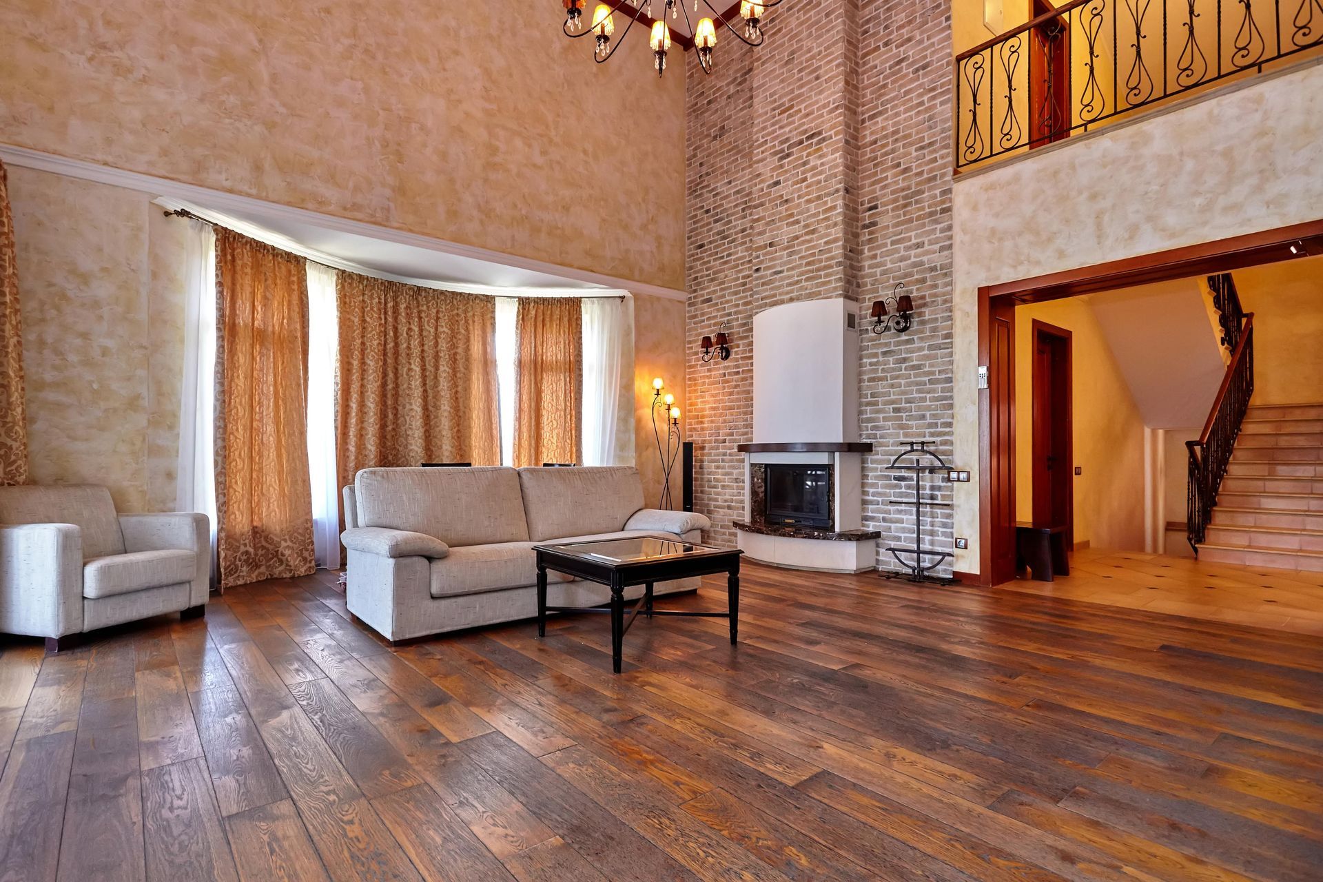 A living room with a couch , chairs , coffee table and fireplace.