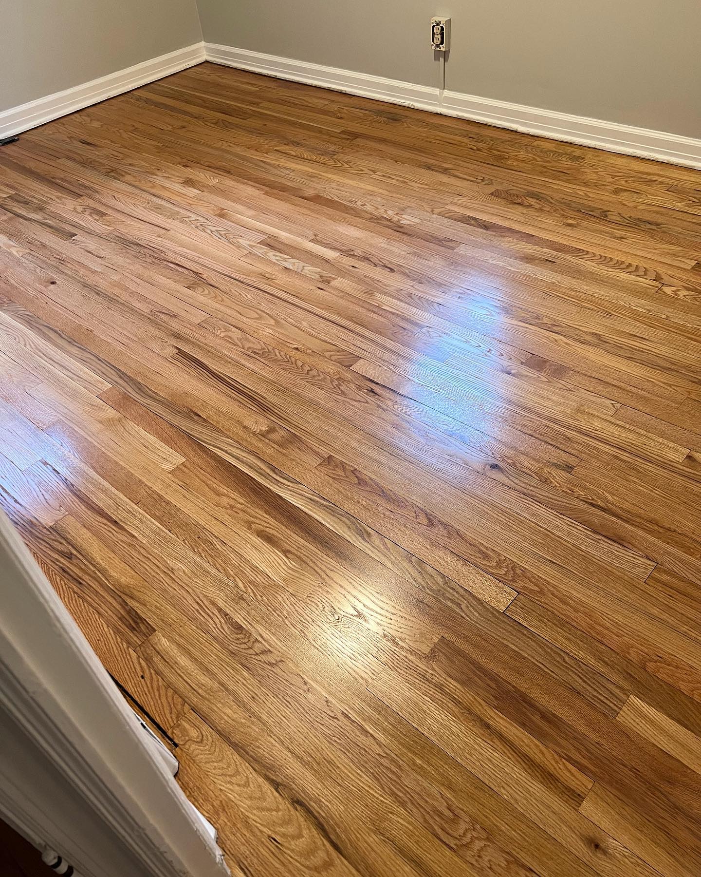 A room with hardwood floors and a staircase.