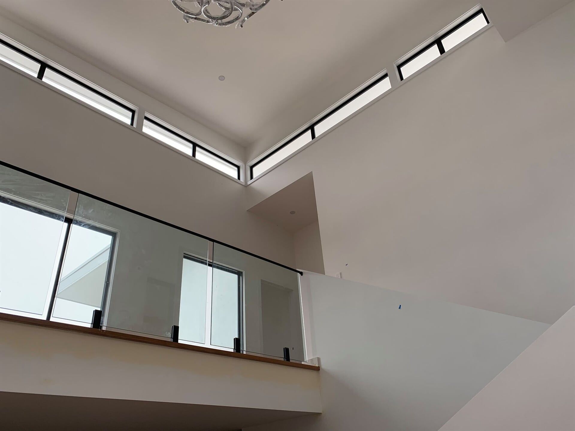 A Balcony With a Glass Railing and Lots of Windows in a House — Plaster Installation in Bensville, NSW