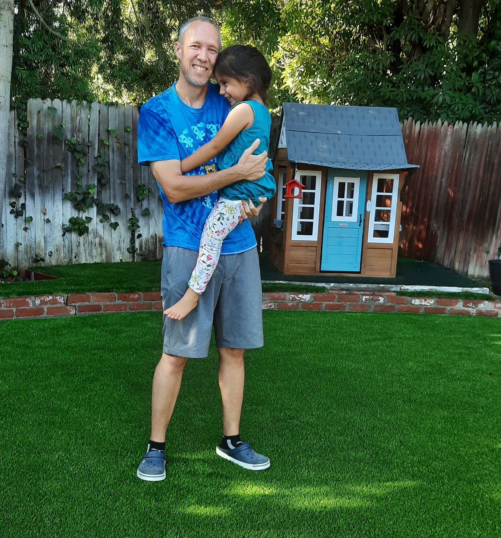 family enjoying artificial grass yard