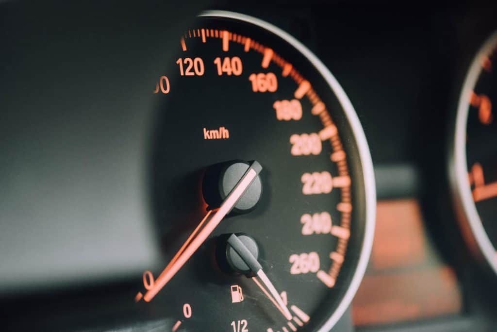 Dashboard with illuminated speedometer displaying speed of about 75 km/h.