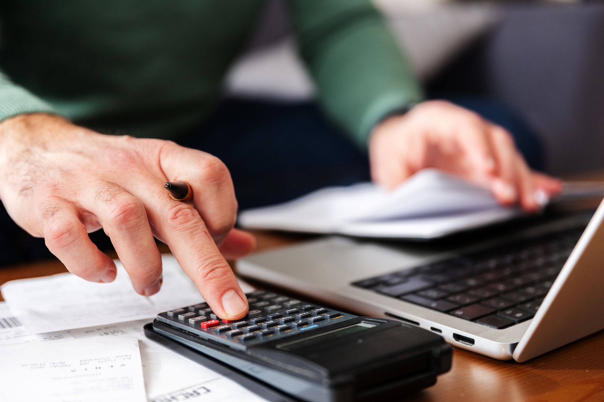 A man calculating taxes for his client A man calculating taxes for his client