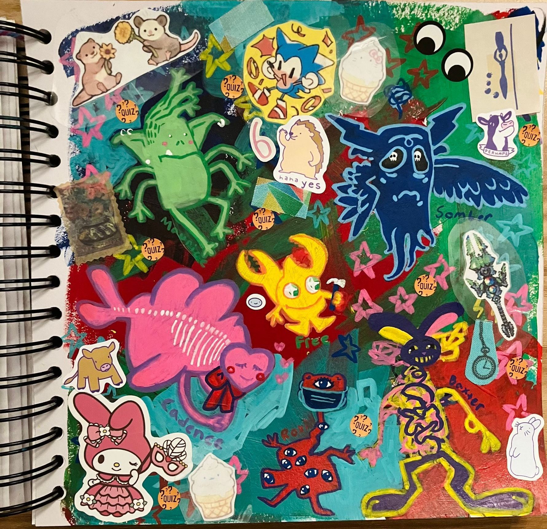A spiral notebook with a drawing of a monster and a pink skeleton