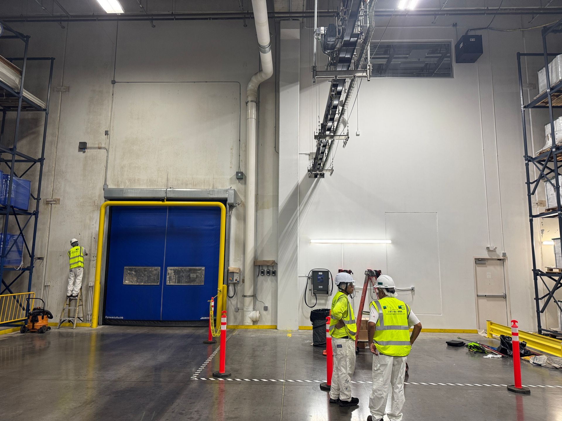 Preparing to apply industrial wall coatings inside a Houston food storage warehouse.