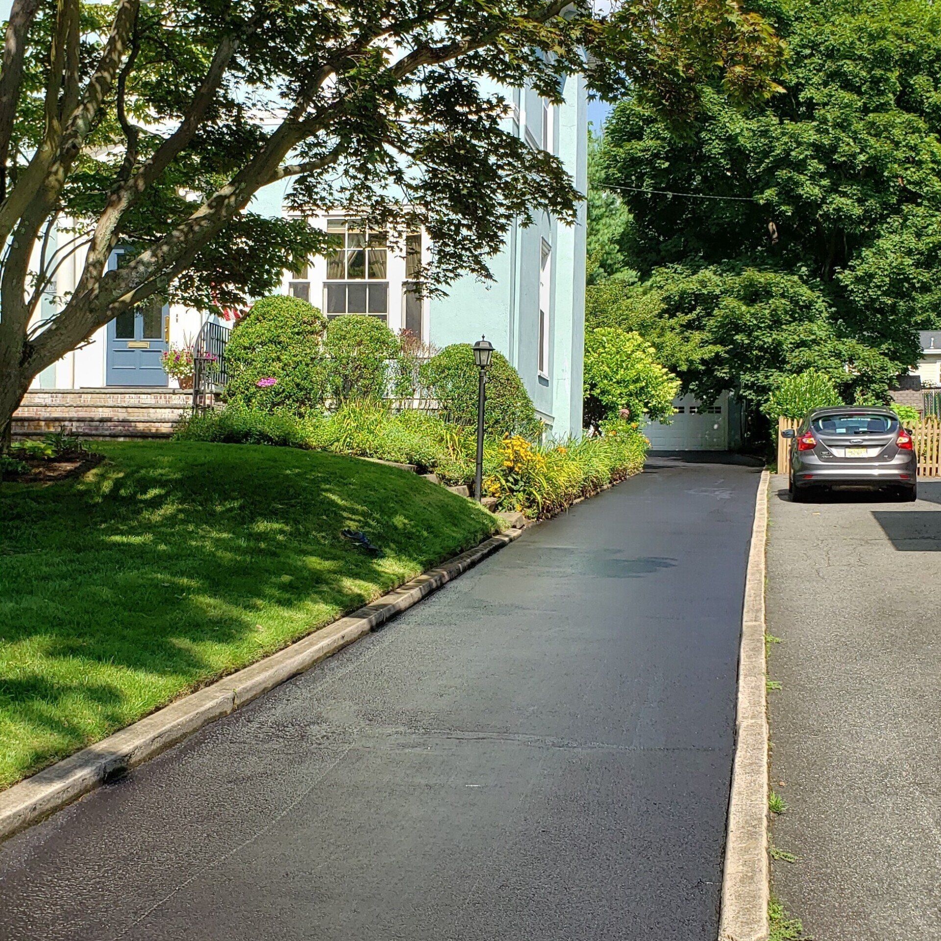 Driveway sealcoating.