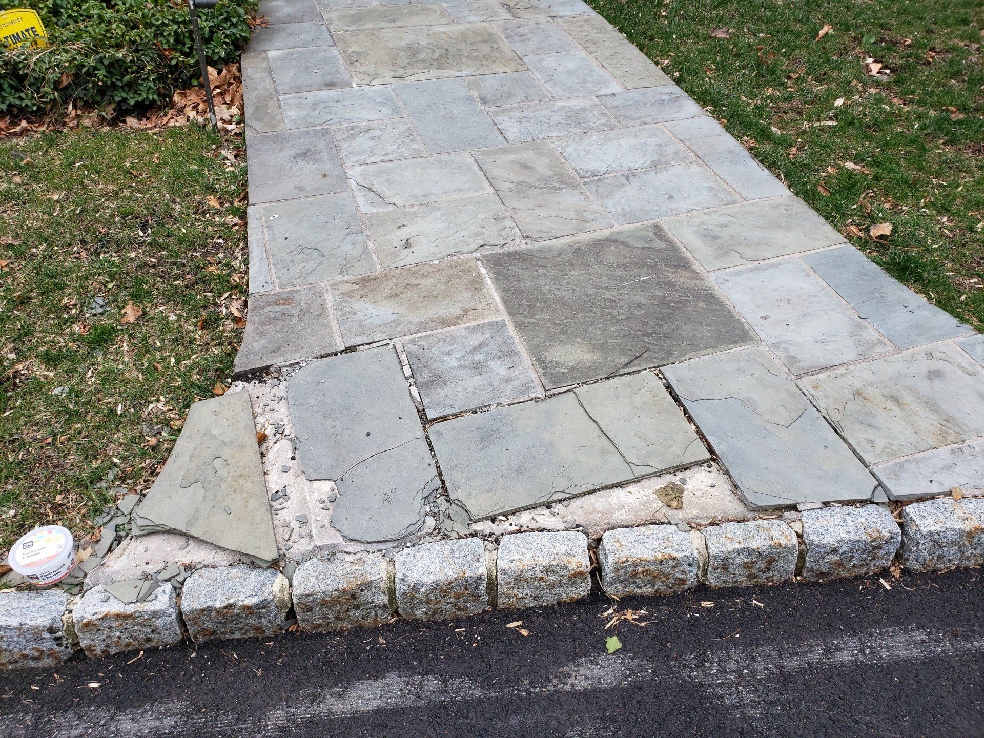A stone walkway with a corner that is missing