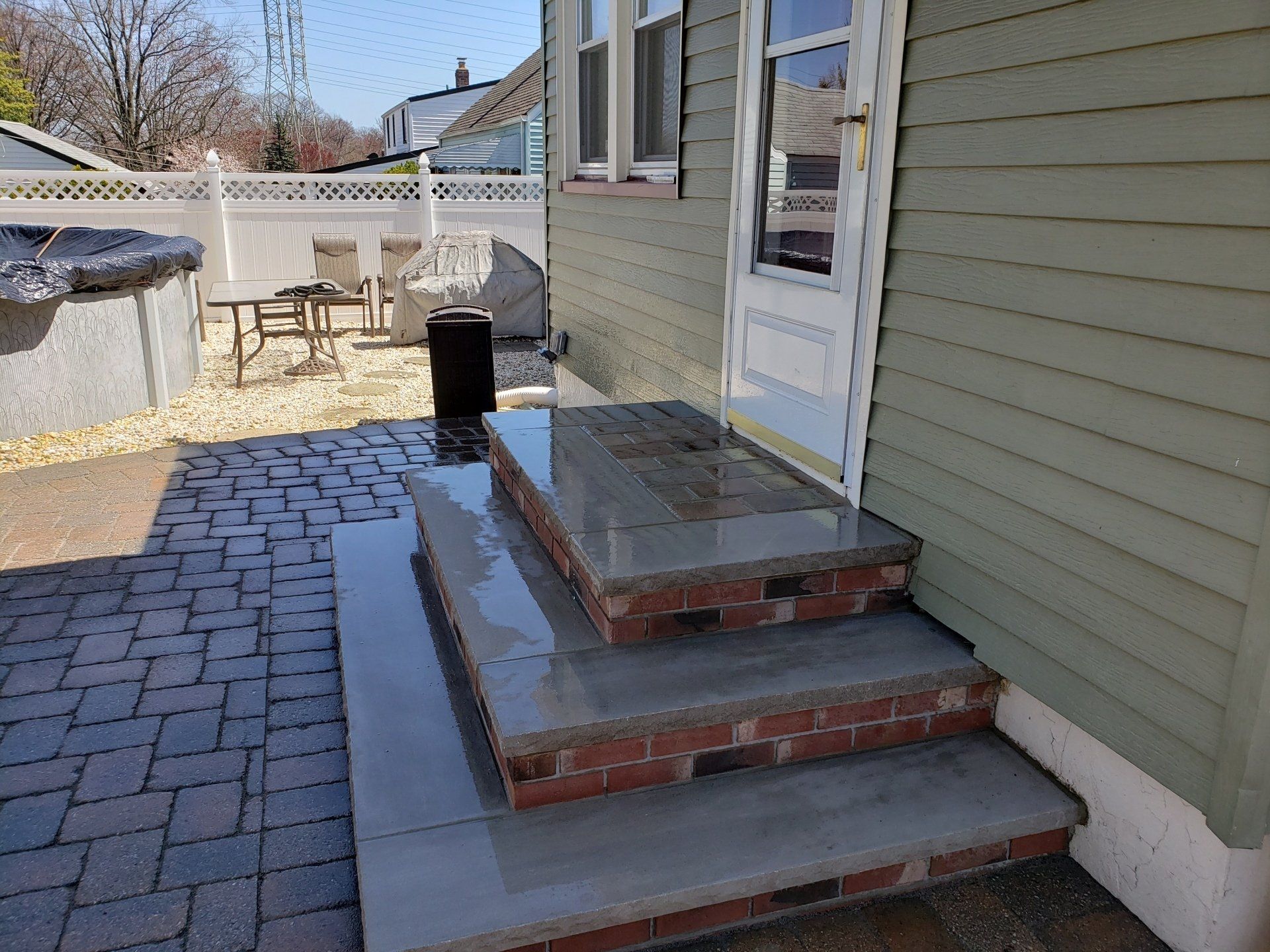 A house with brick steps leading up to the front door.