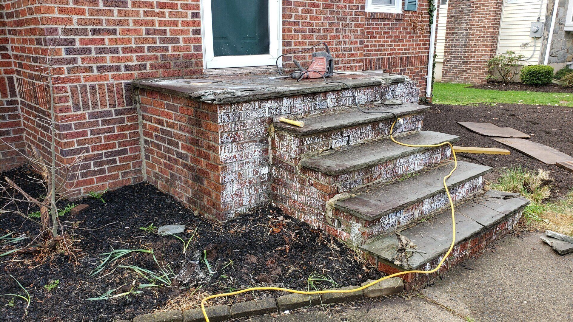A brick house with a set of stairs leading up to it.