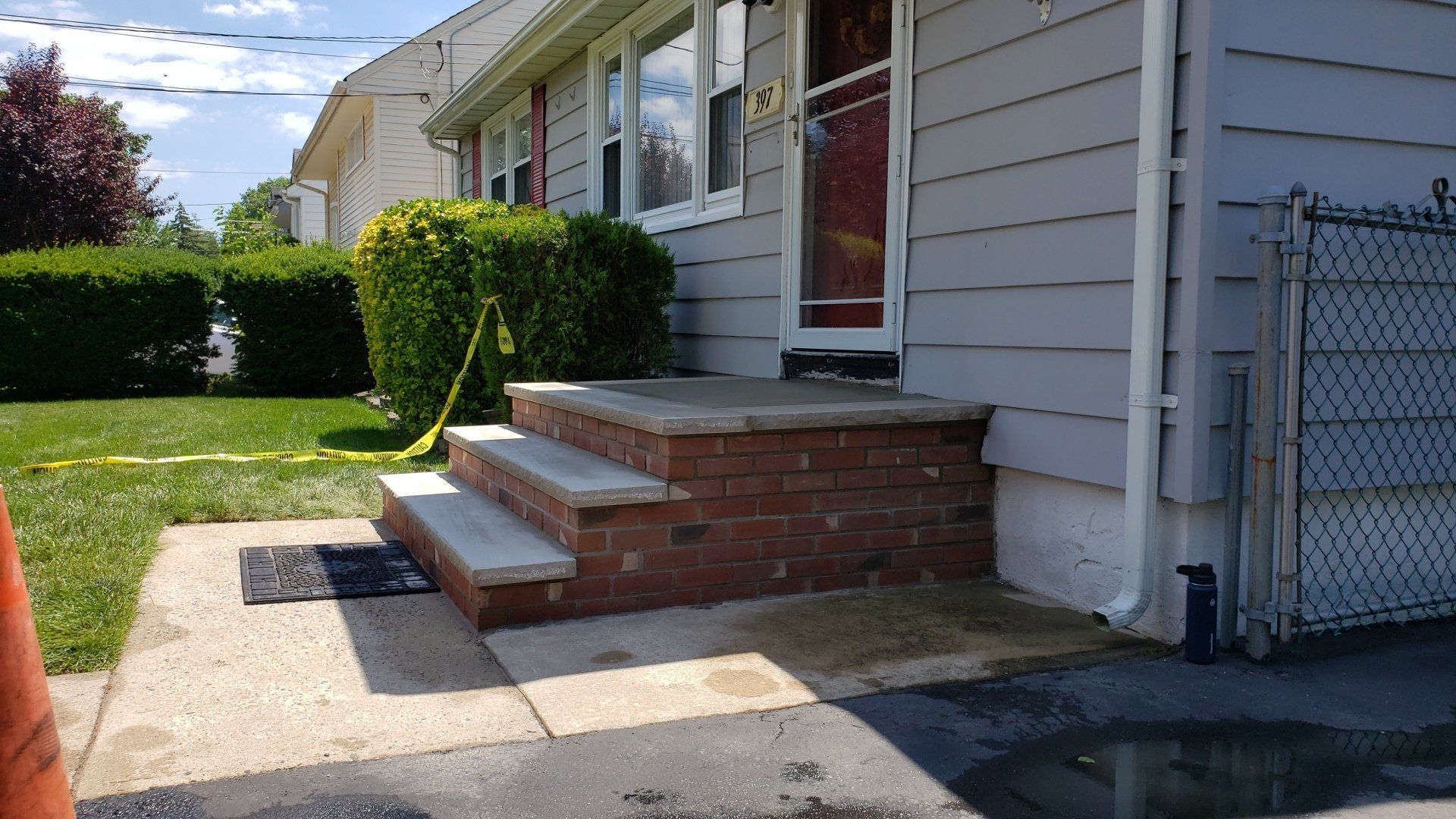 A house with brick steps leading up to the front door.