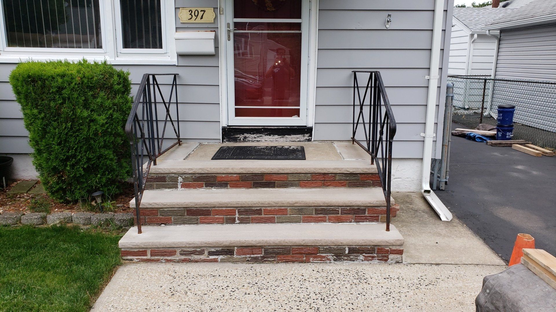 A house with brick steps leading up to the front door.