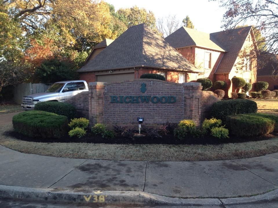 A brick sign in front of a house that says buckwood