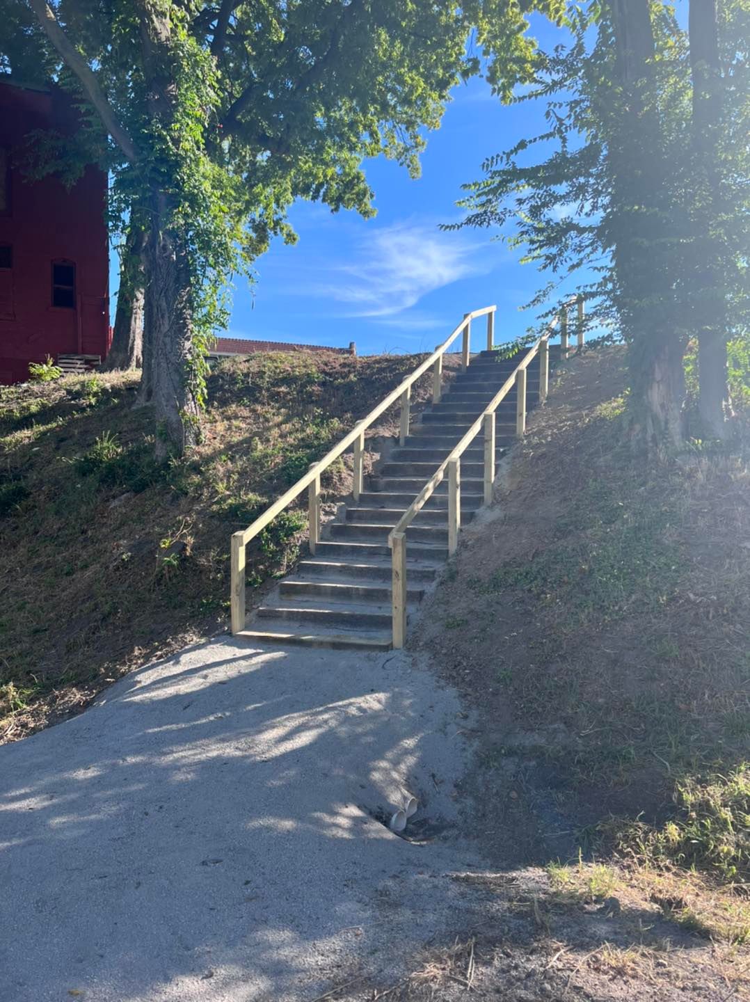 A set of stairs leading up to a red building