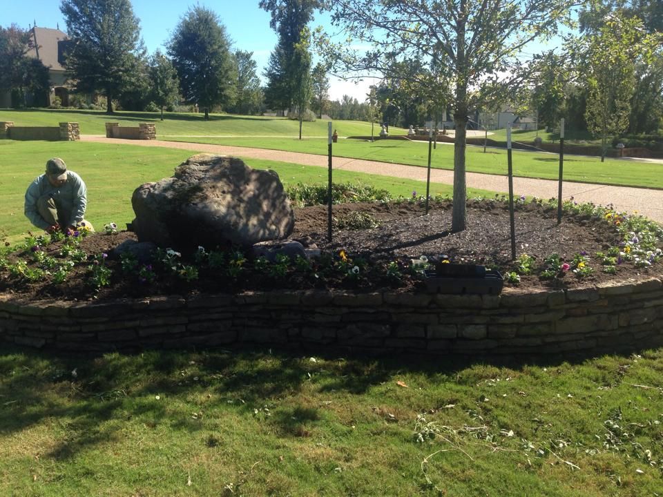 A man is working on a garden in a park