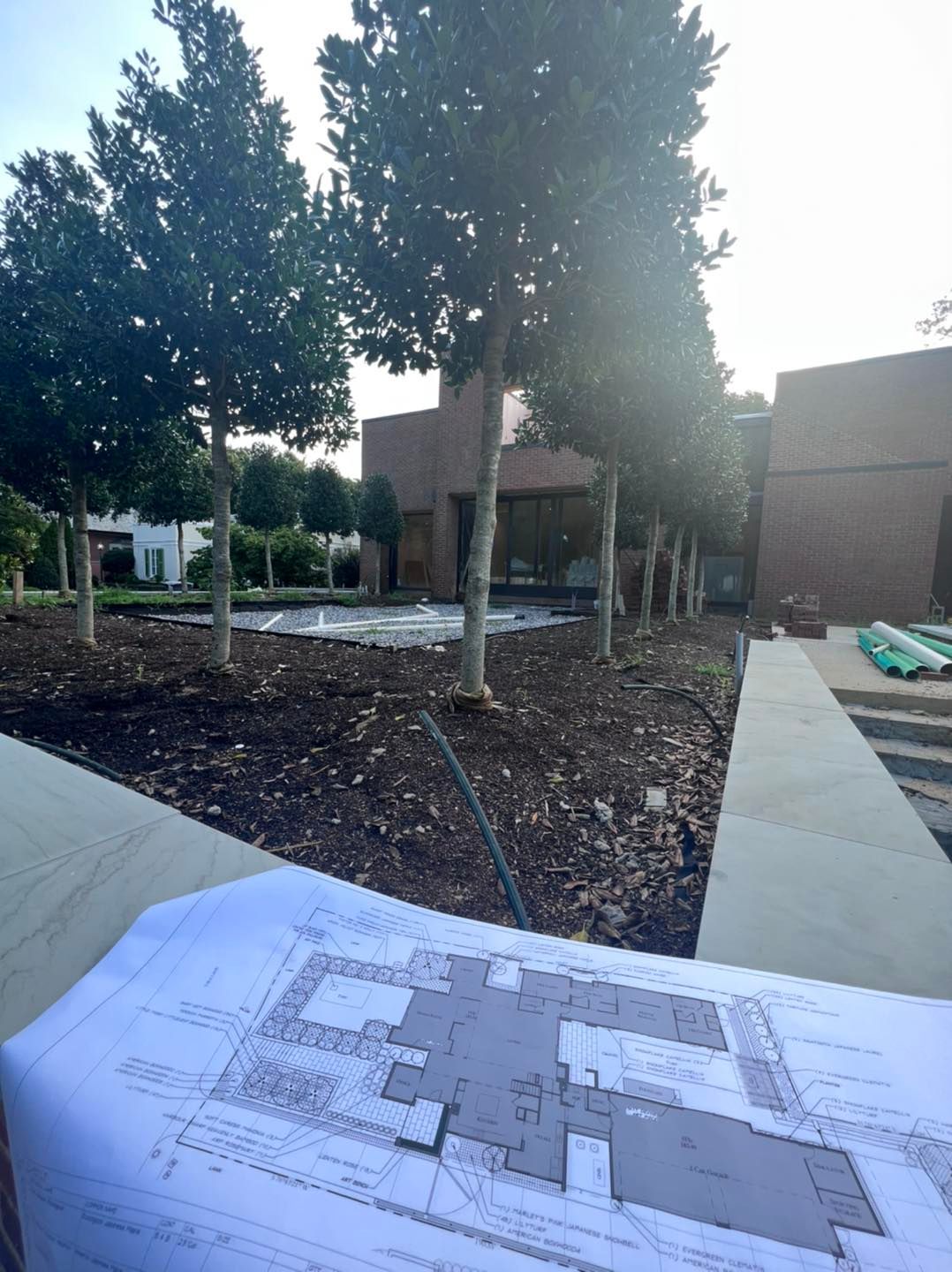 A drawing of a building is sitting on a table in front of a building.