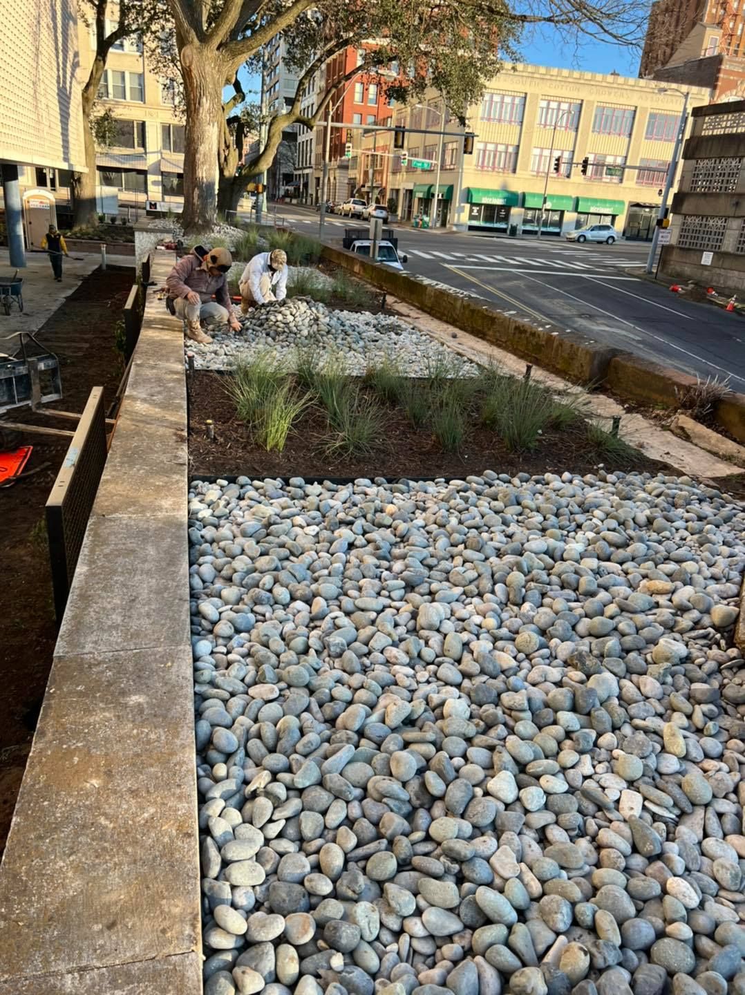 A pile of rocks is sitting on the side of a road.
