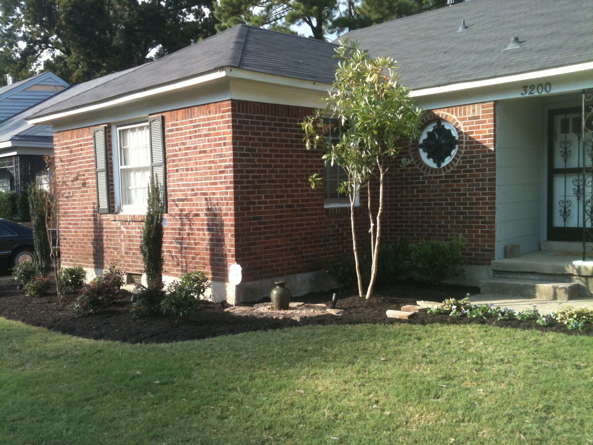 A small brick house with a gray roof