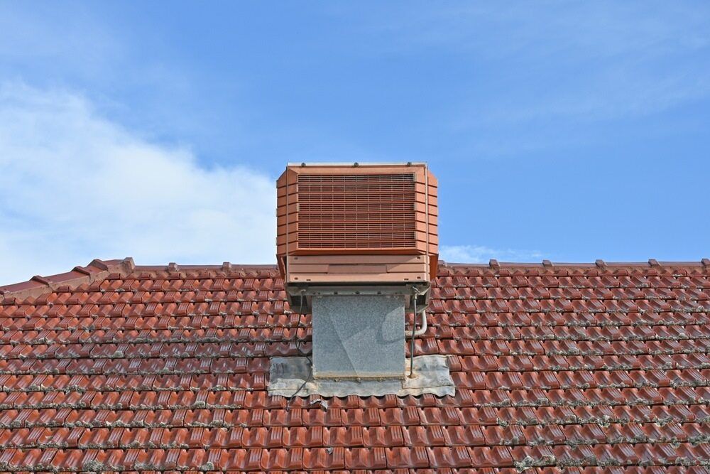 A Brick Chimney On Top Of A Red Tiled Roof — PalmAir Heating & Cooling Specialists In Tumbarumba, NSW
