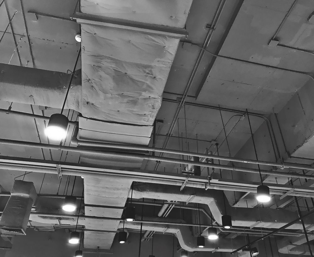 A Black And White Photo Of A Ceiling With A Lot Of Pipes — PalmAir Heating & Cooling Specialists In Wagga Wagga, NSW