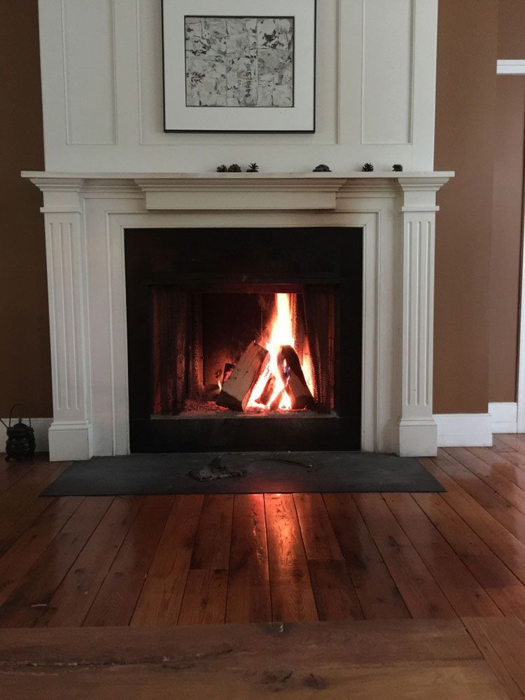 A Fireplace With A Picture On The Wall Above It — PalmAir Heating & Cooling Specialists In Wagga Wagga, NSW