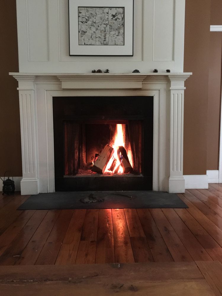 A Fireplace With A Picture On The Wall Above It — PalmAir Heating & Cooling Specialists In Gundagai, NSW