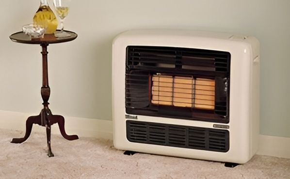 A Gas Heater Is Sitting Next To A Small Table In A Living Room — PalmAir Heating & Cooling Specialists In Wagga Wagga, NSW