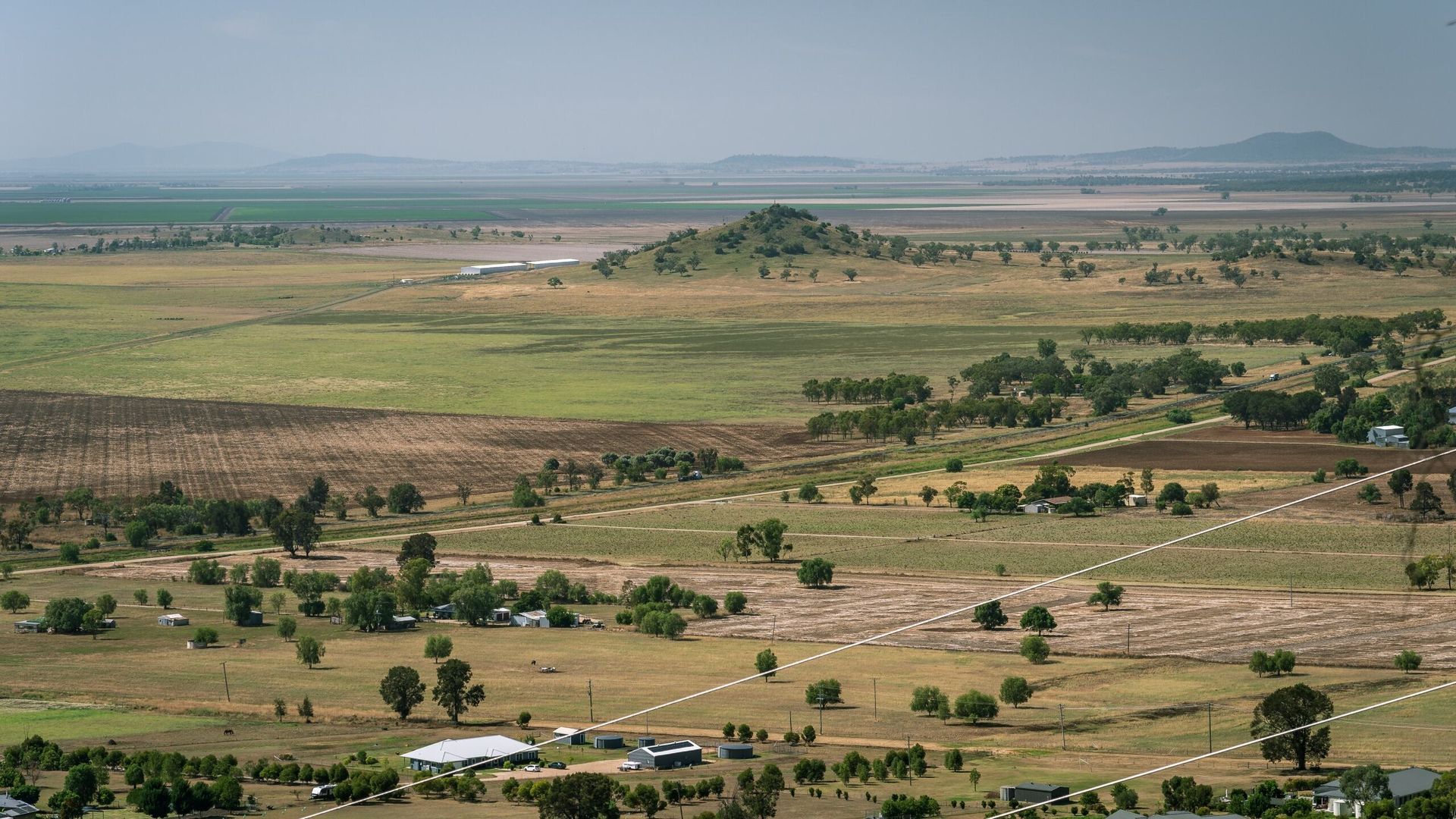 An Aerial View Of A Lush Green Field With Trees And Houses — PalmAir Heating & Cooling Specialists In Narrandera, NSW