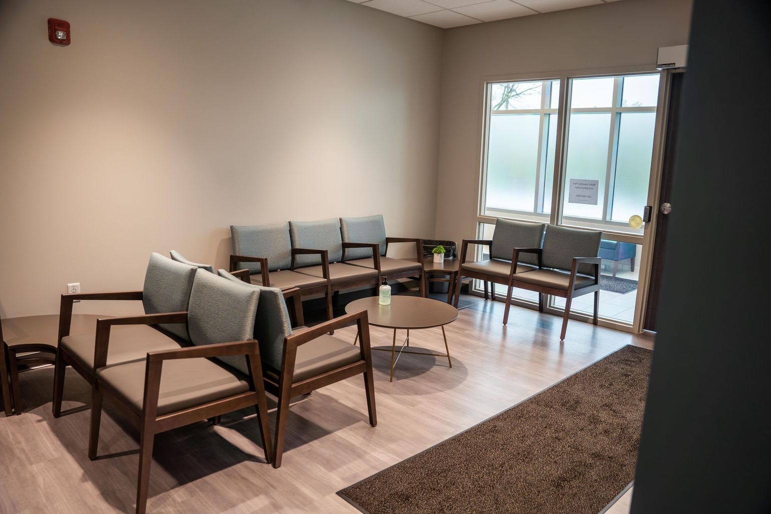 a waiting room with a lot of chairs and a table .