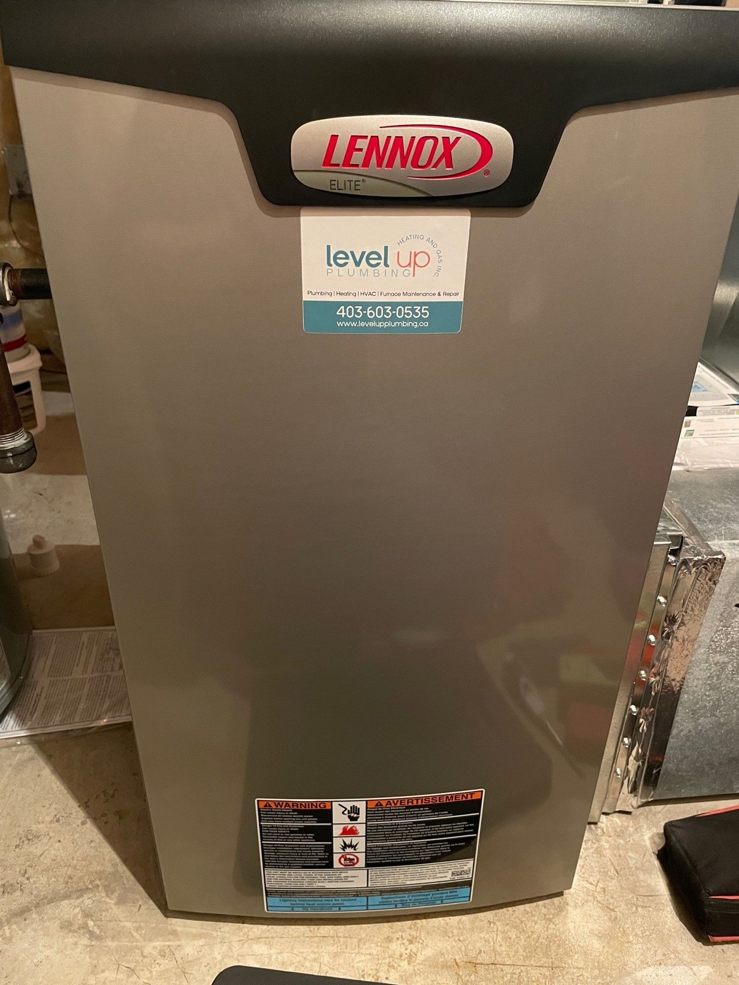 A Lennox brand furnace with a Level Up sticker