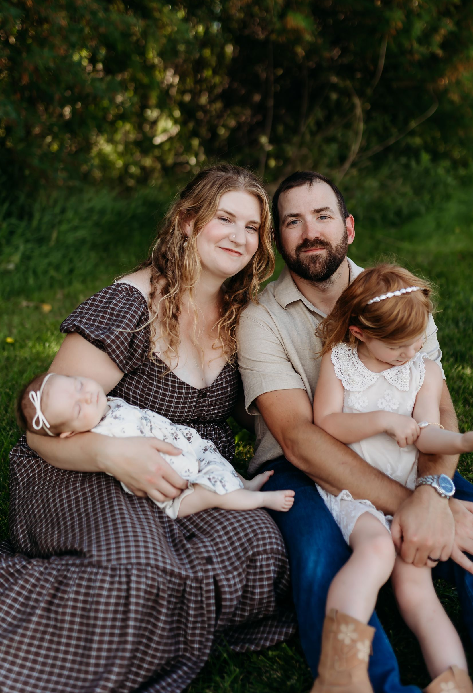 A family photo of Owners, Brian Wota and Caitlin Bohm, with their daughter.