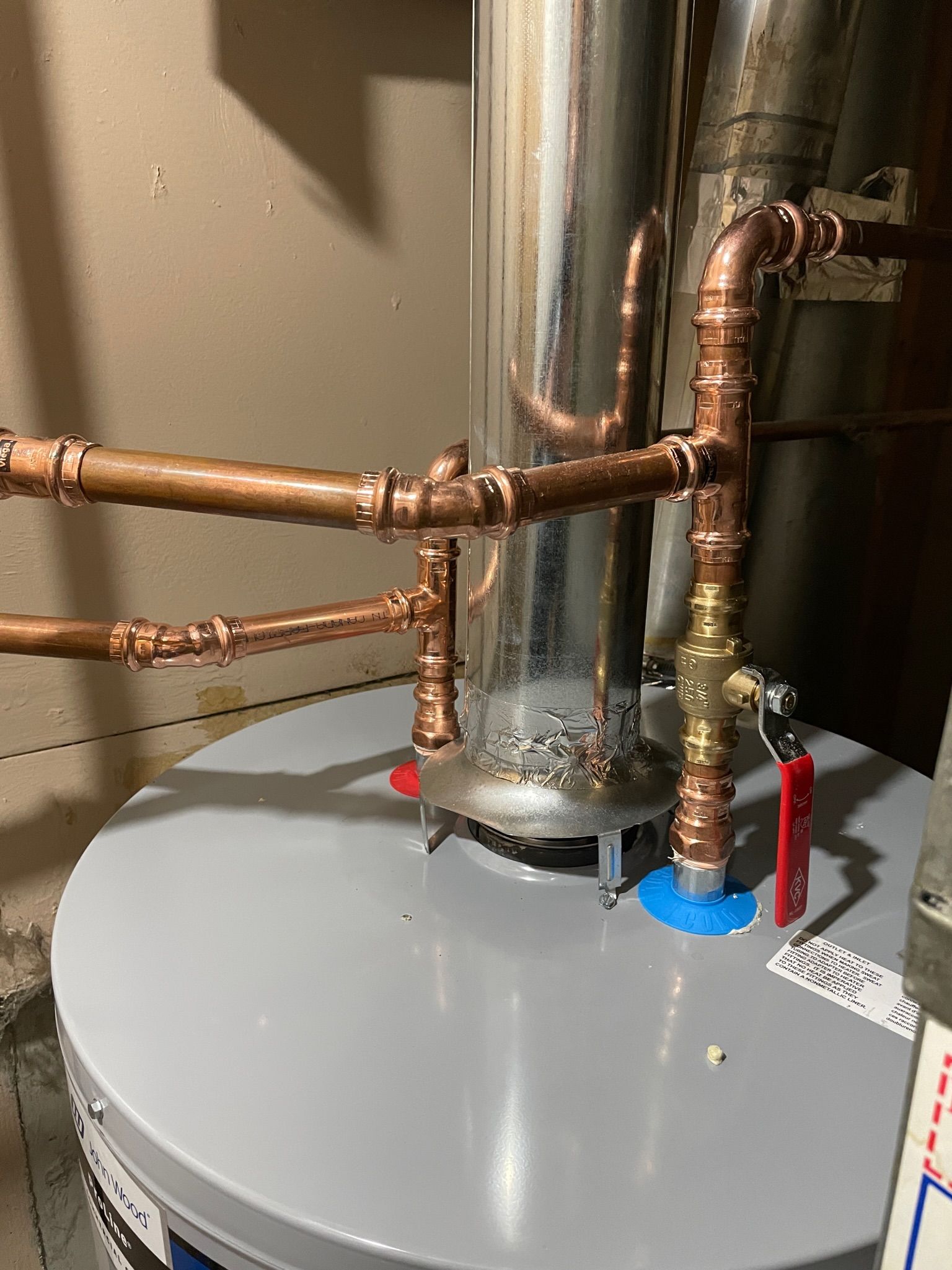 A water heater with water lines and venting
