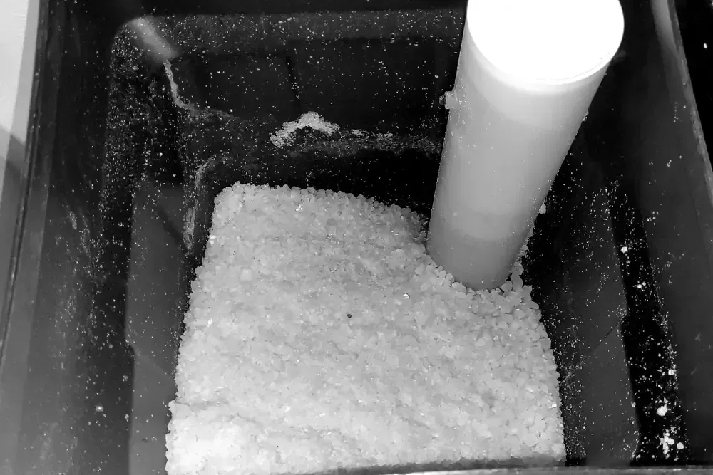 Revitalize Your Water Quality with Our Expert Water Softener Services In Okotoks - Picture of water softener Salt Pellets inside a water softener system.