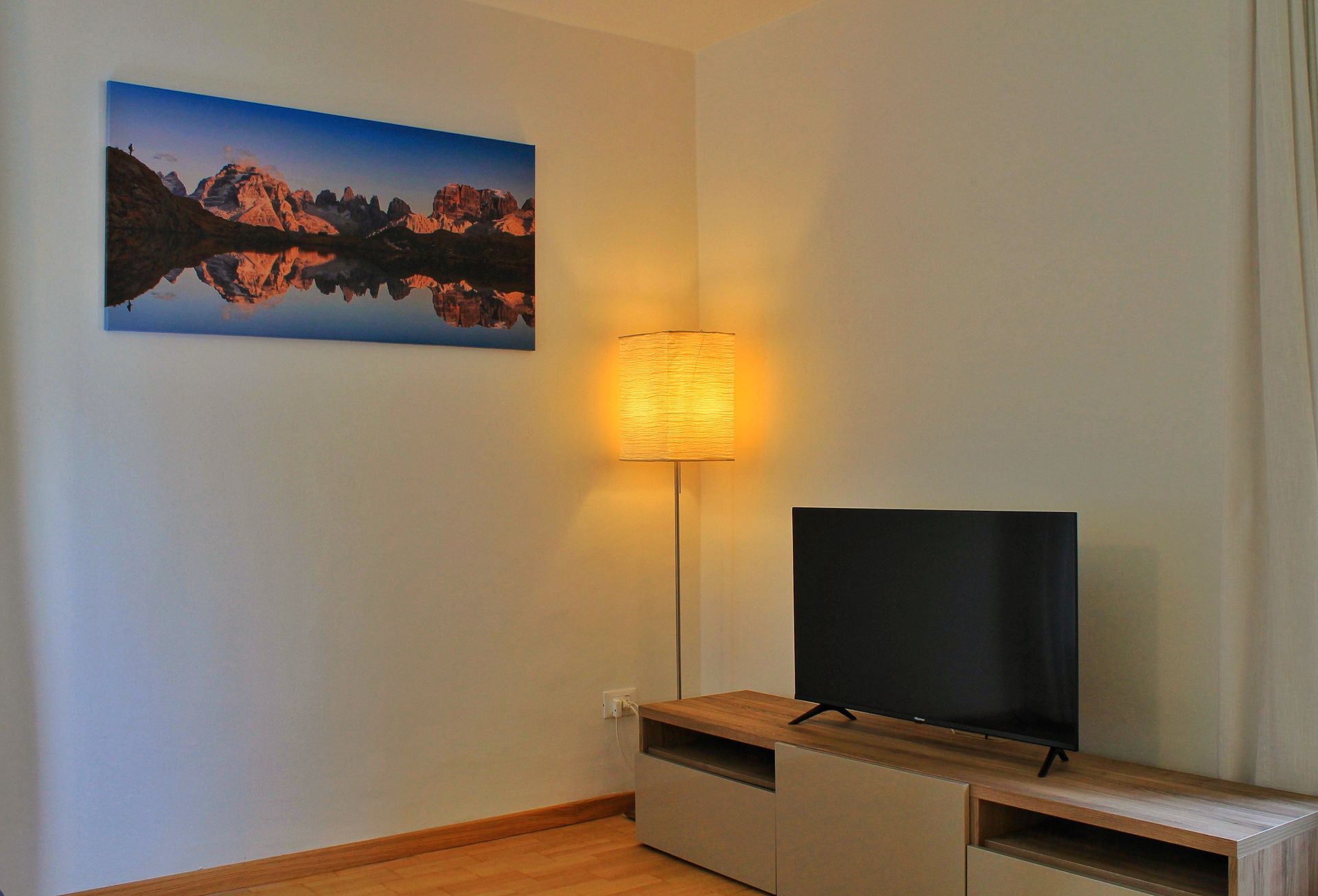 Un soggiorno con TV a schermo piatto e un quadro alla parete.