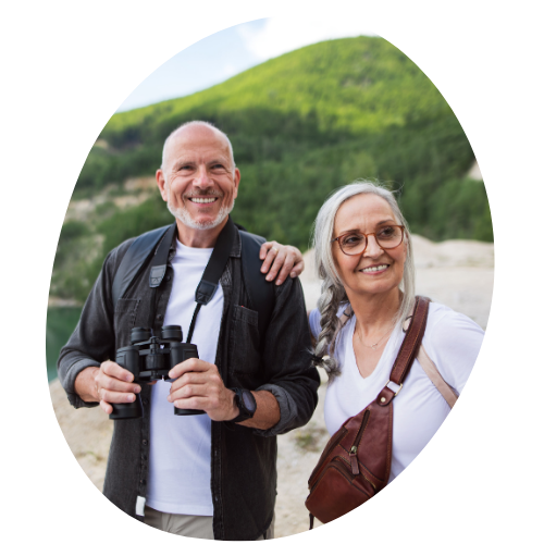 A man and a woman are standing next to each other holding binoculars.