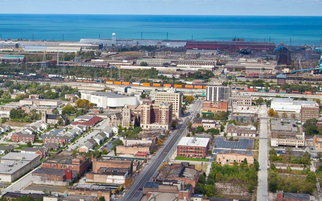 An aerial view of a city with a large body of water in the background.