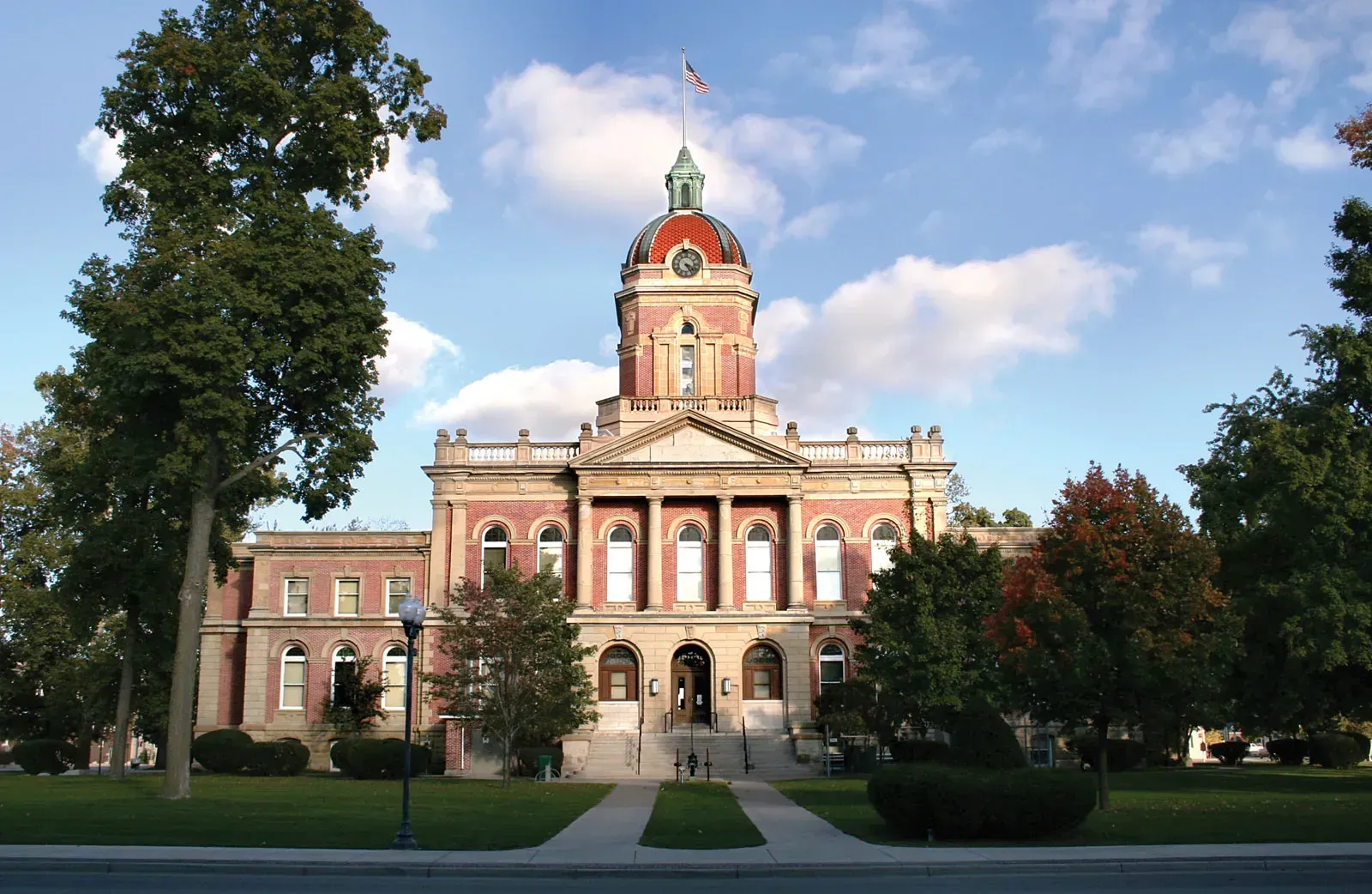 a large brick building with a flag on top of it