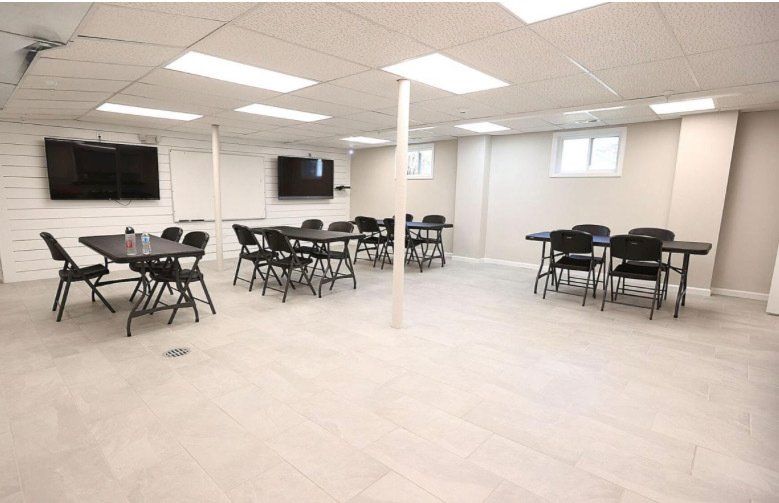 A large room with tables and chairs in it