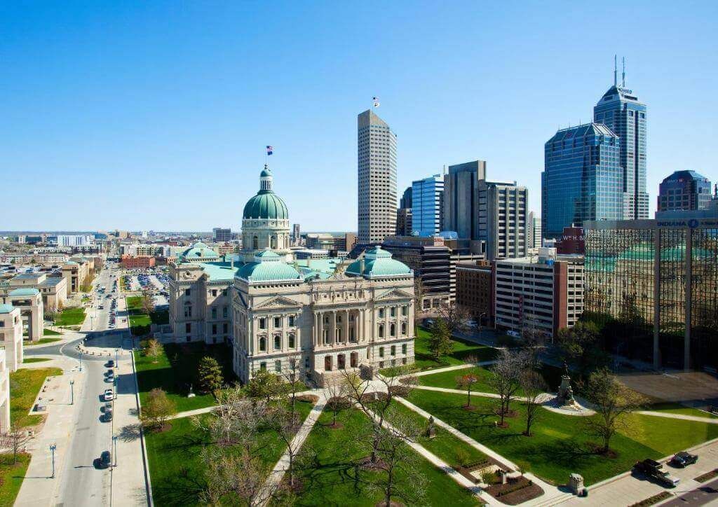 An aerial view of a city with a large building in the foreground.