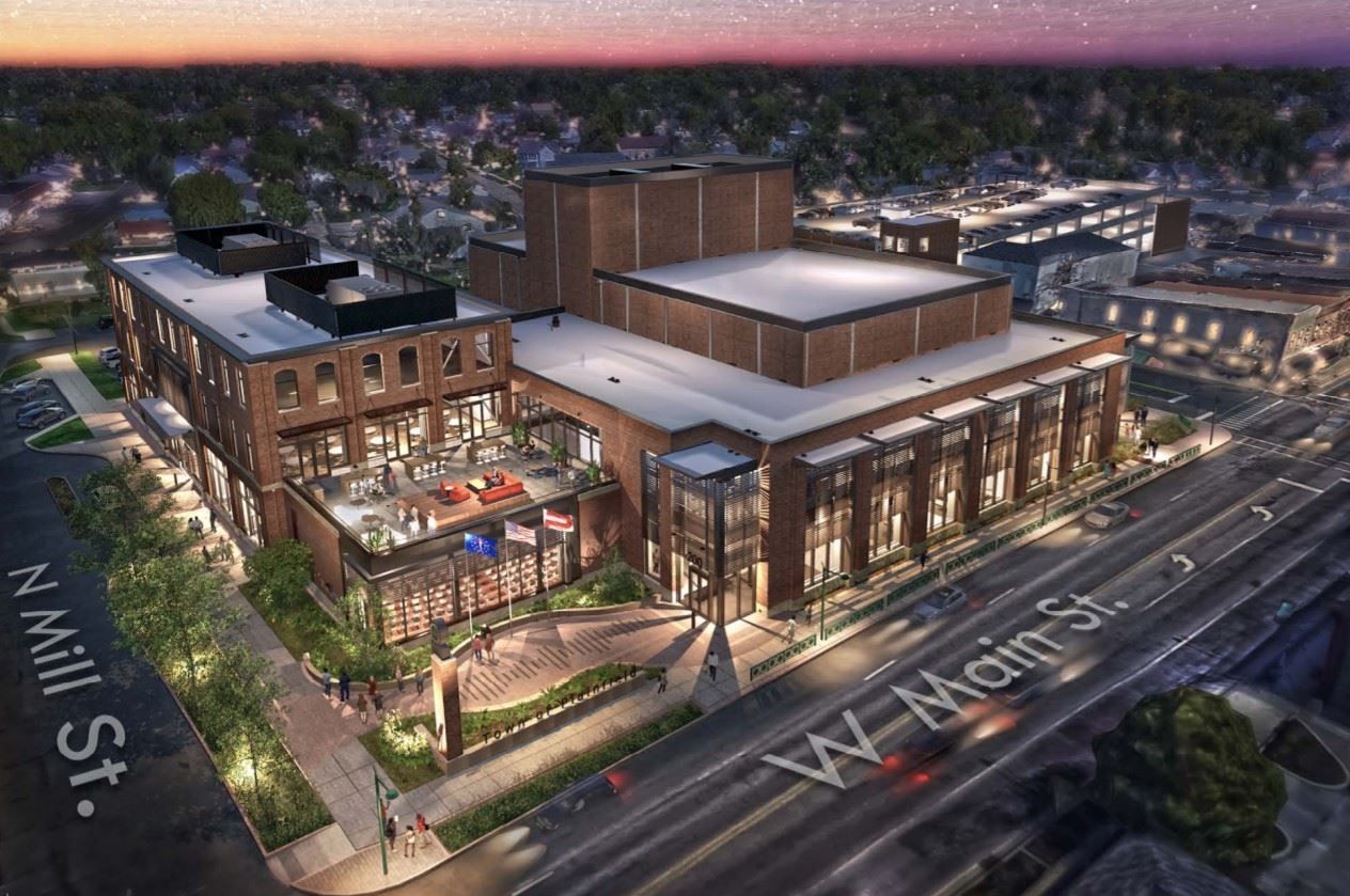 An aerial view of a large brick building in a city.