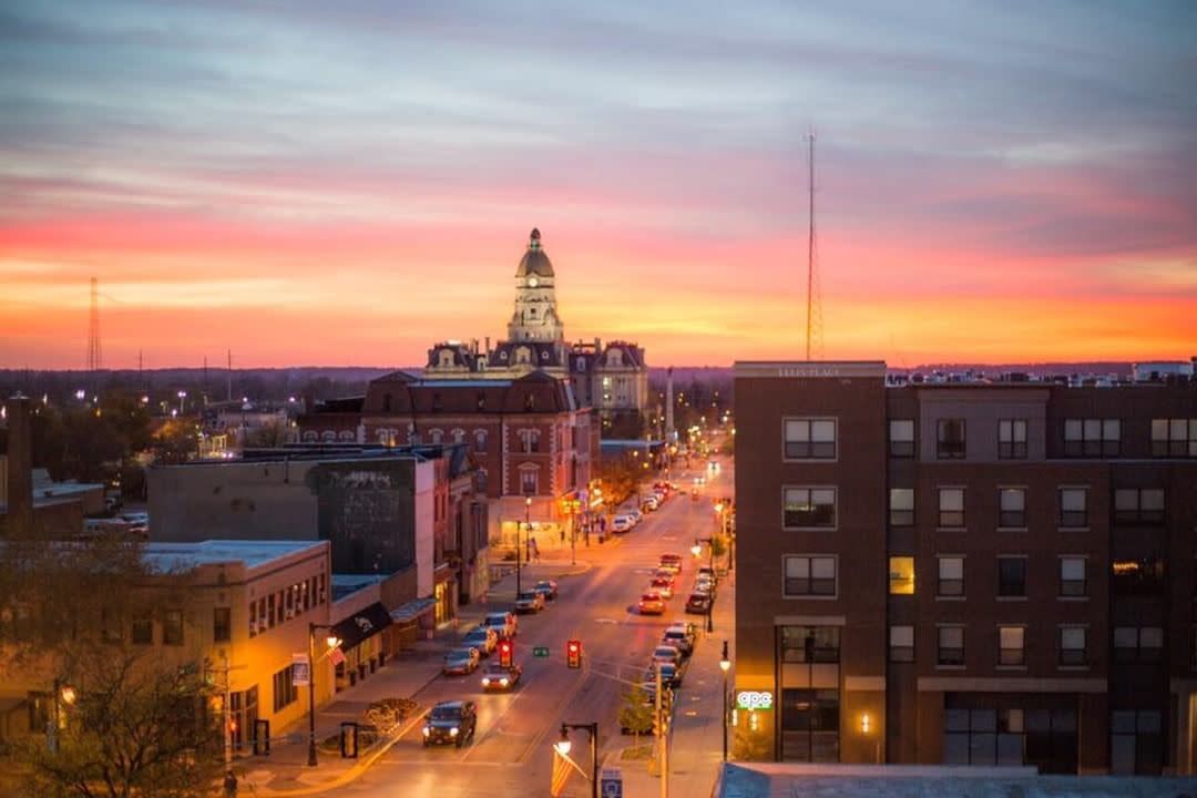An aerial view of a city street at sunset.