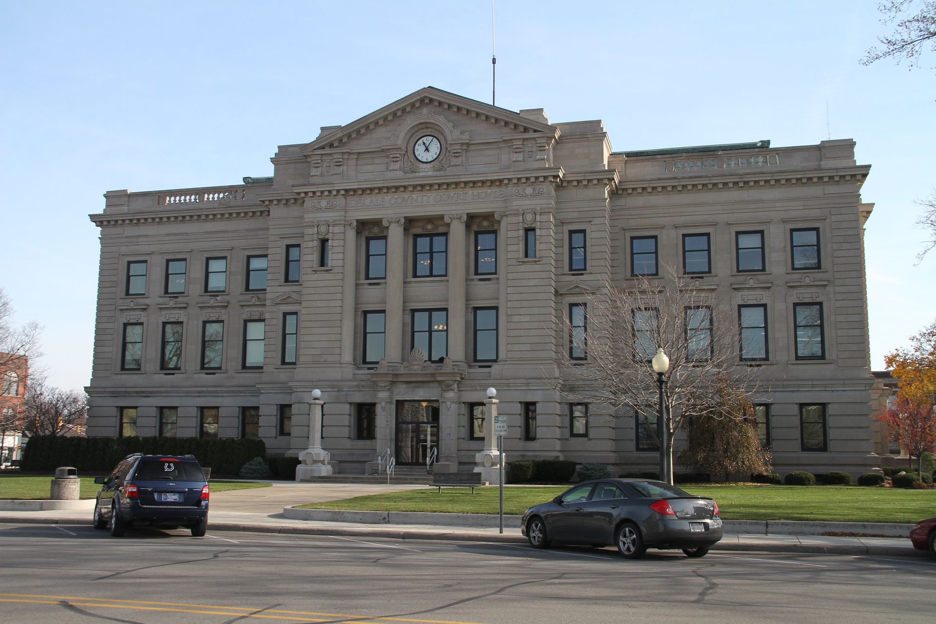 A large building with cars parked in front of it