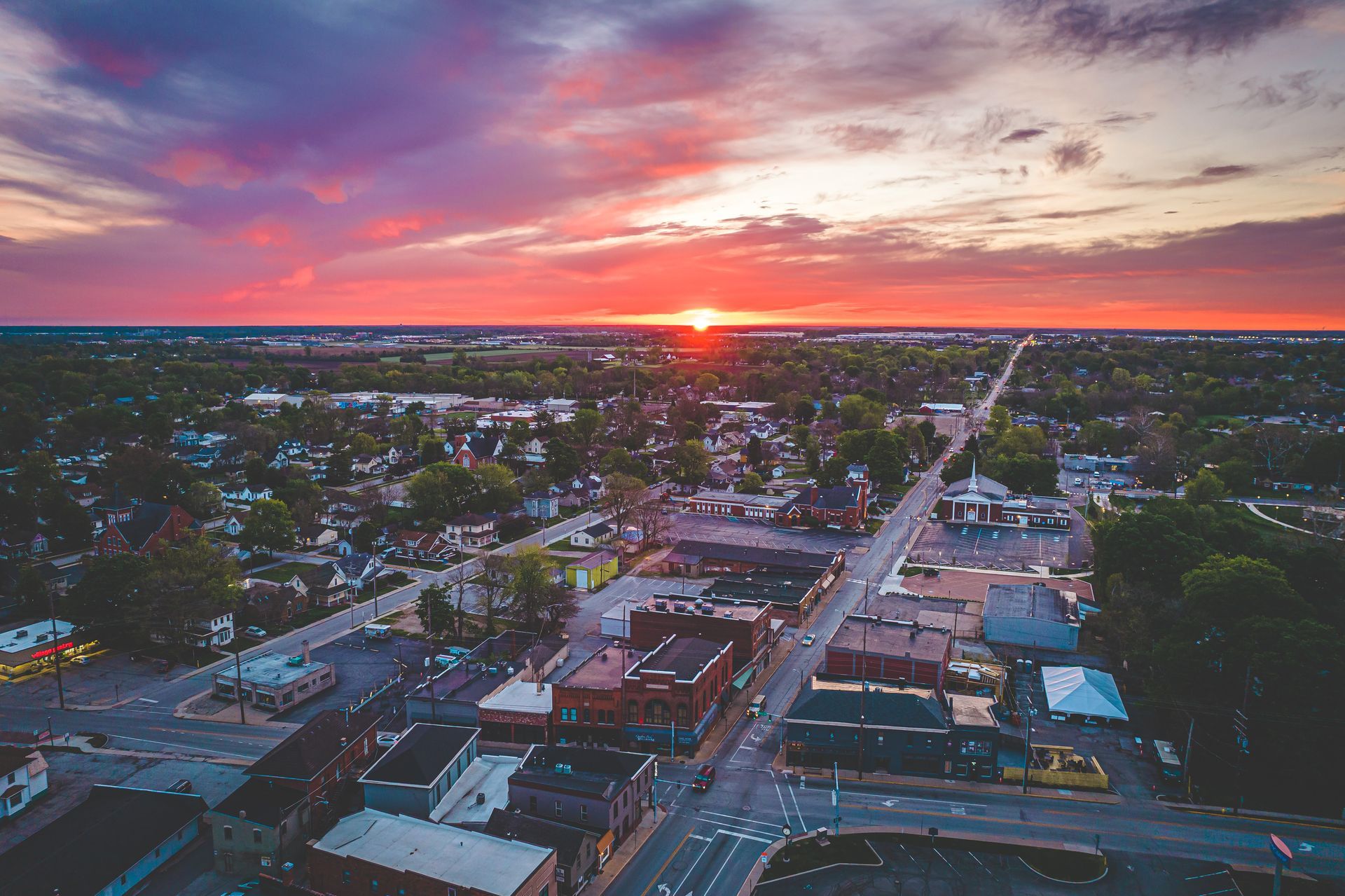 An aerial view of a small town at sunset.