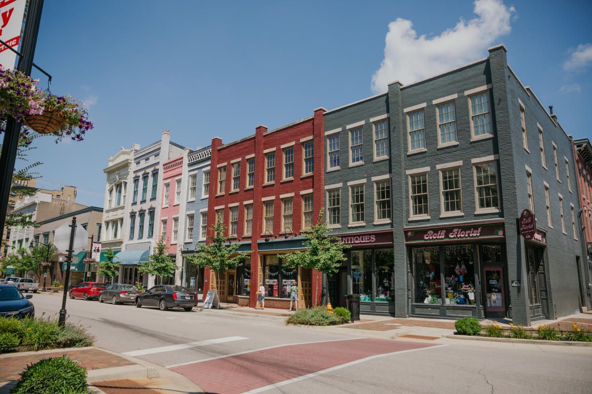 A row of buildings are lined up on a city street.